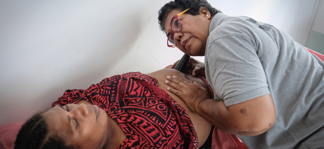 Midwife Kinisena Bolalevu uses a fetoscope at the Vanuatu Family Health Association clinic. She’s a retired midwife from Fiji who is part of the response to the recent disasters in Vanuatu. The use of fetoscopes, a widely-adopted practice across the globe, demonstrates adaptability in scenarios where advanced technology like foetal dopplers may not be accessible or operational. Kinisena sees around 80 patients a day to provide care. She also mentors young nurses. Familial pressures,fears of potential domestic violence, and discussions about family planning can be challenging, sometimes even drawing blame towards healthcare workers. In reflecting on her work, Kinisena shares, "It's a delicate balance, often fraught with fear. Many wives do not disclose their family planning methods to their husbands because they fear gender-based violence. And many times, these cases of violence remain unreported. Once, a policewoman confided in me at the clinic that health workers are often seen as culprits in these instances. It's a heartbreaking reality, but we strive to navigate these complexities, ensuring women's safety and rights are protected. The clinic stands as a beacon of support for women navigating these complexities.” ©UNFPA/David Palazón