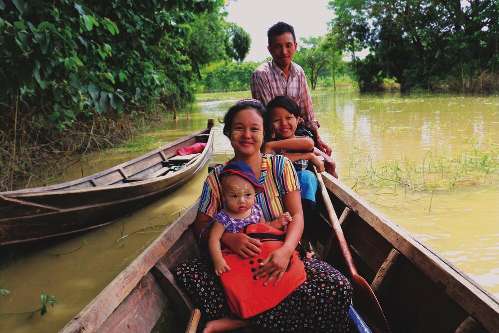 A woman receives a UNFPA Dignity Kit during a flood in Myanmar.