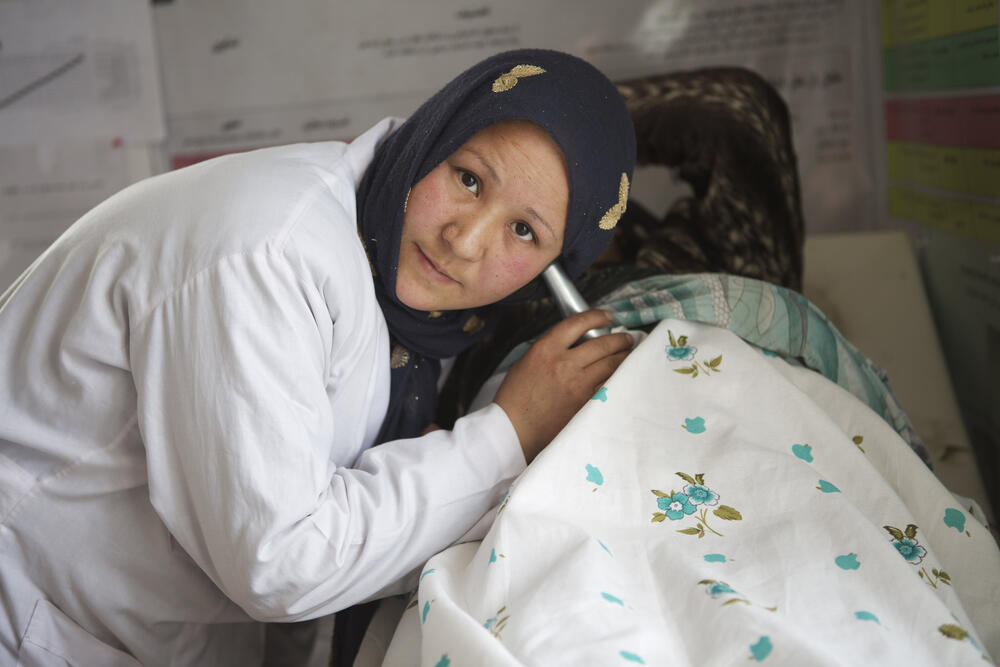 Health professional checking a pregnant woman's belly