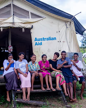 group of people outside a tent