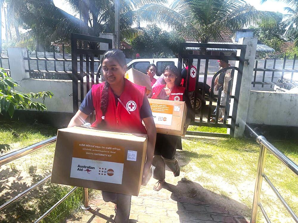 Partners carrying boxes with supplies from UNFPA