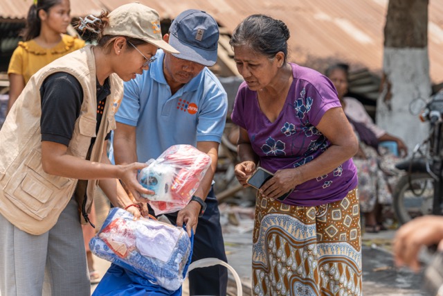 Figure 3: A woman affected by earthquake receive relief items including UNFPA's dignity kits during UN joint distribution in Sagaing. Photo © UNFPA Myanmar