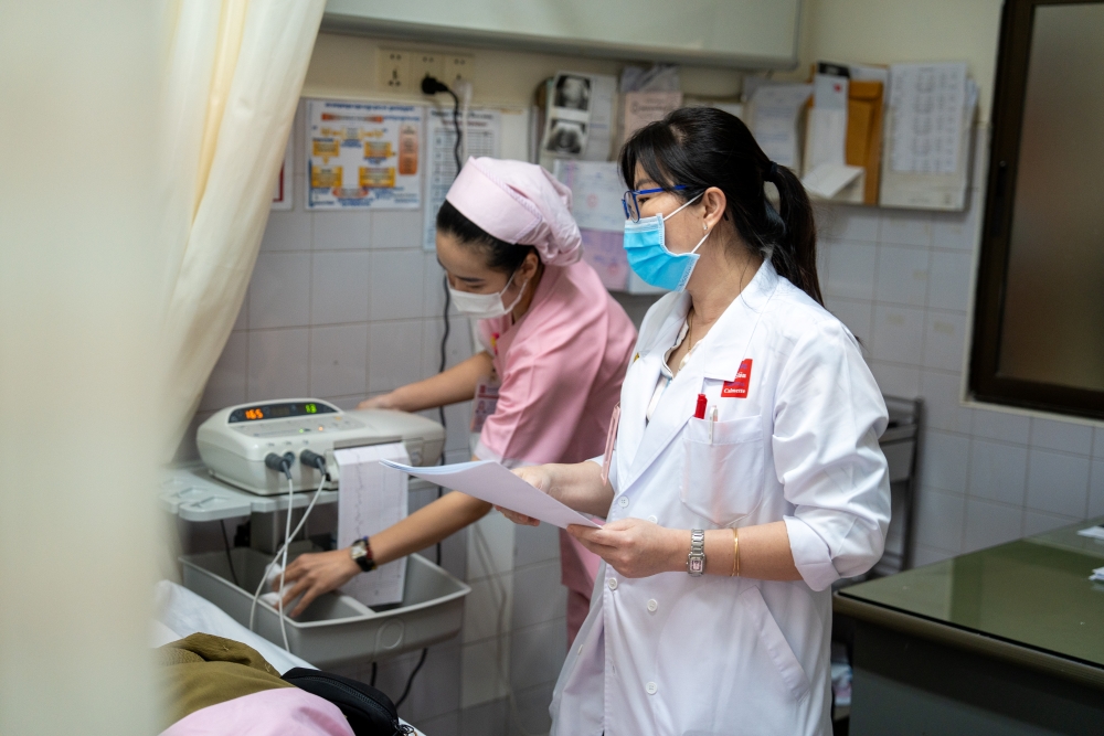Female doctor and female nurse examining a pregnant patient in the hospital