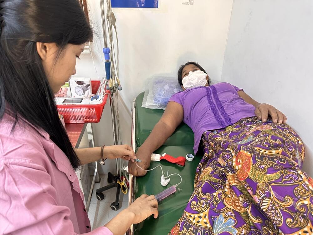 A woman affected by the earthquake in Myanmar receives primary healthcare at a UNFPA-supported mobile clinic in Mandalay, 30 March 2025 (Photo: AFXB Myanmar/UNFPA Myanmar)