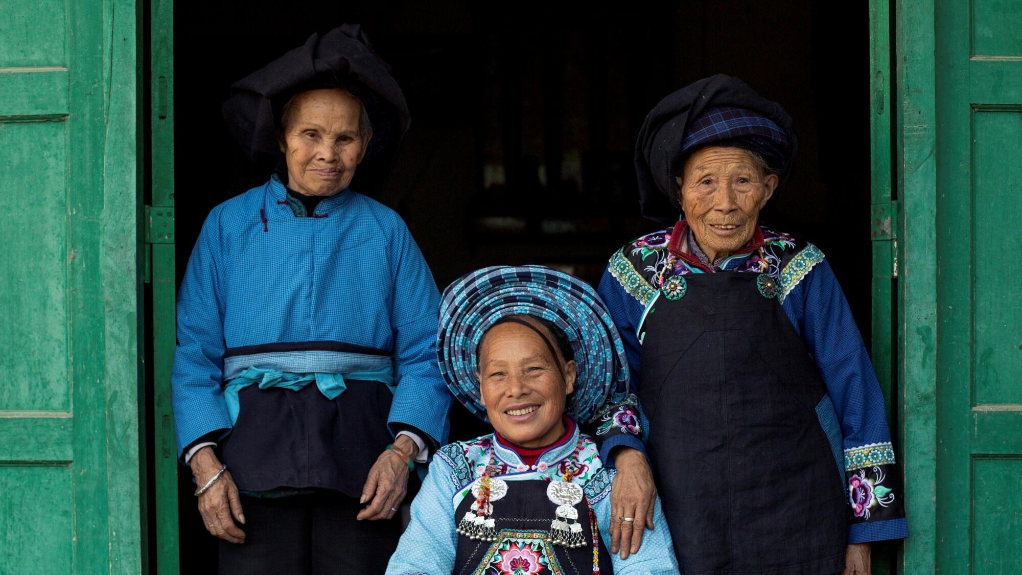 Three women from a small village in China, wearing traditional clothes