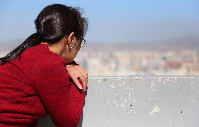 A woman looks out over the landscape in Mongolia