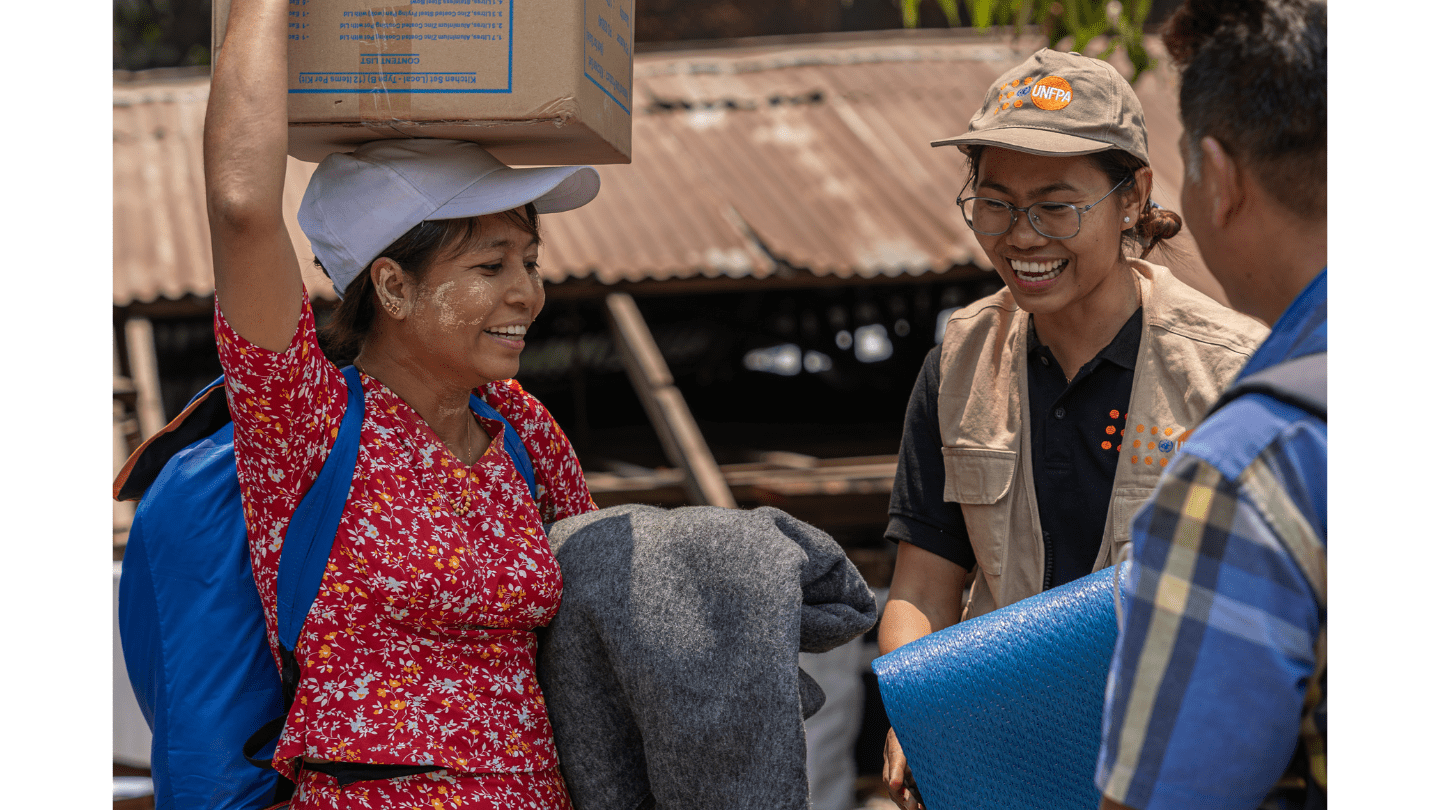 Figure 1: A woman affected by the earthquake receives relief items including UNFPA's dignity kits during the UN joint distribution in Sagaing. Photo©UNFPA Myanmar