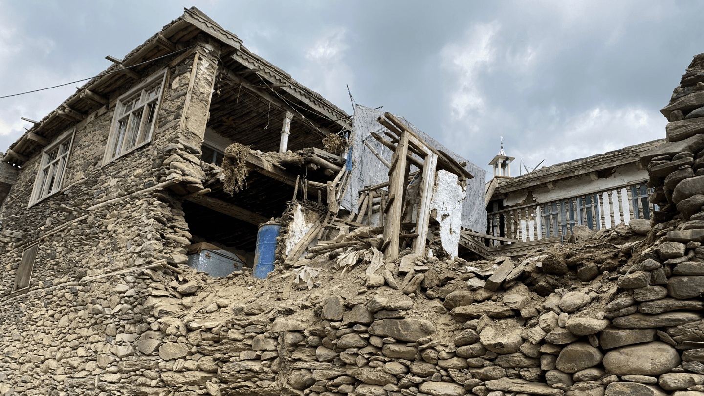 A photo of a house destroyed by an earthquake