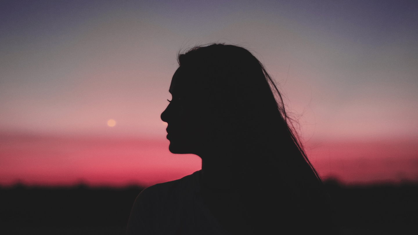 Photo of a woman's silhouette against the sunset