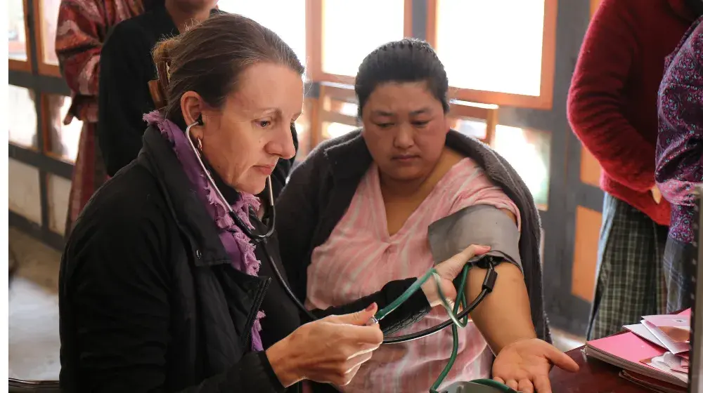 Catherine screens a woman in Bhutan for NCDs